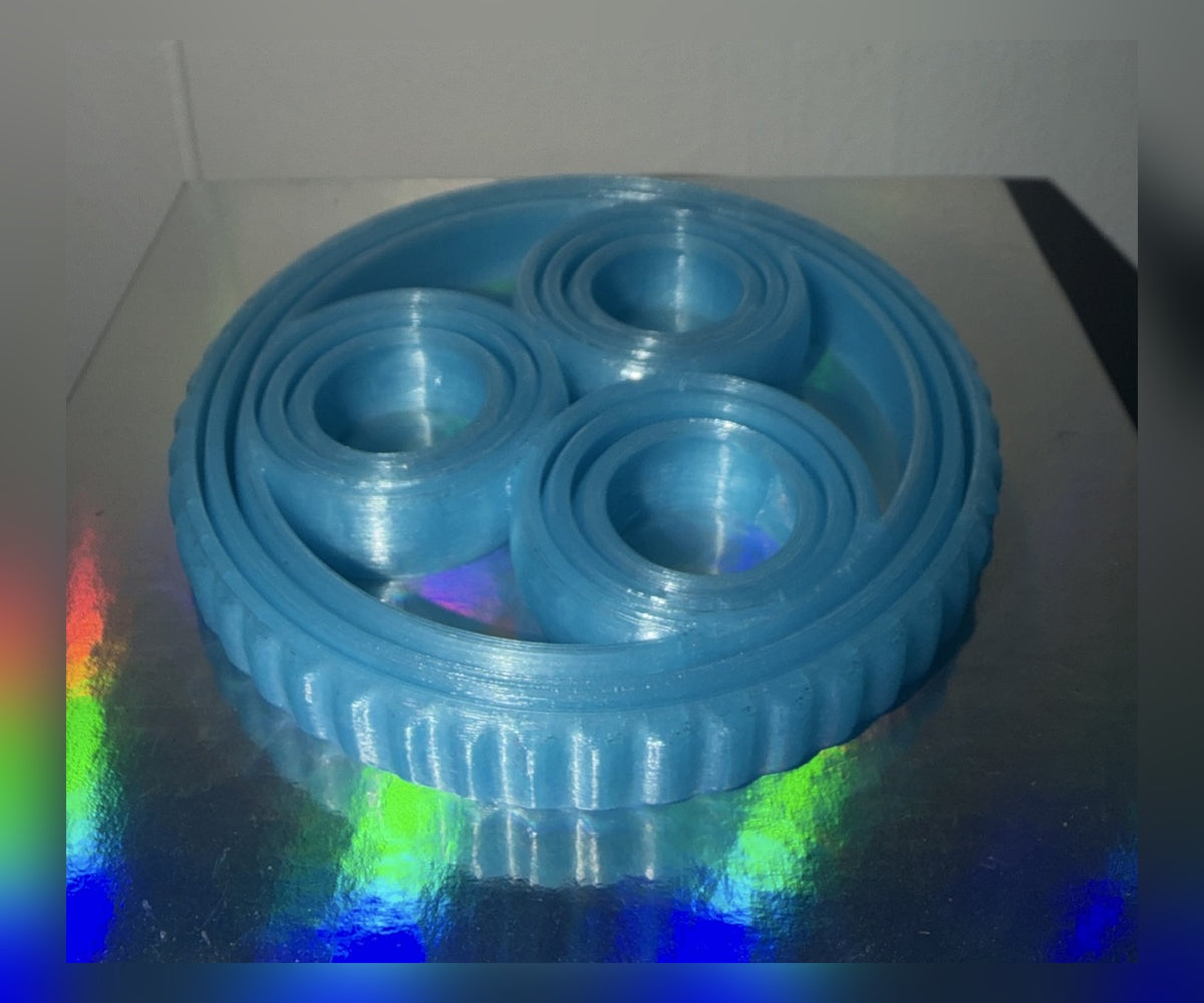 Rotating rings fidget toy in light blue, front view