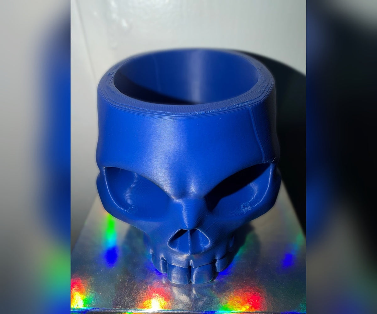 Blue 3D printed skull bowl, angled view